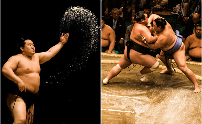 Борцы сумо бросают соль на ринг.