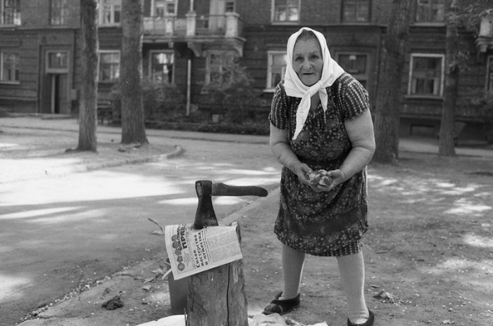 Женщина рубит суповой набор, чтобы приготовить обед. Новокузнецк. 1984 г.