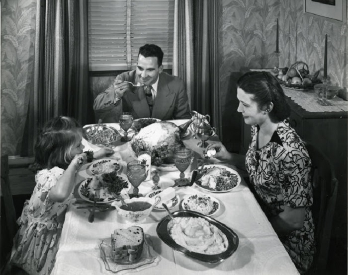 Семья за большим столом отмечает день благодарения. 1945 год.