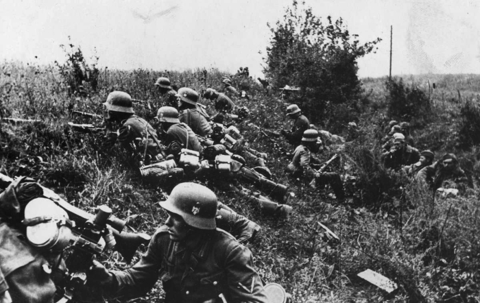 Немецкие солдаты на позиции, а за ними в канаве русские военнопленные. 1941 год. 