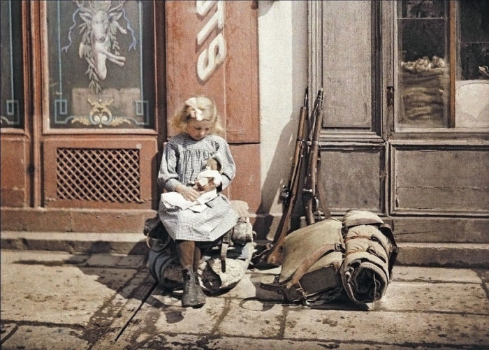 Девочка с куклой рядом с солдатским обмундированием в Реймсе. Франция, 1917 год.