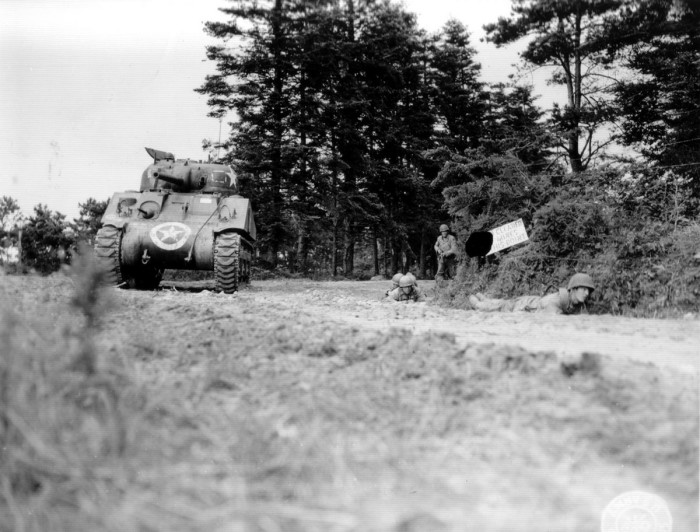 Американцы 90-ой пехотной дивизии укрываются в канаве, рядом с танком «Шерман».